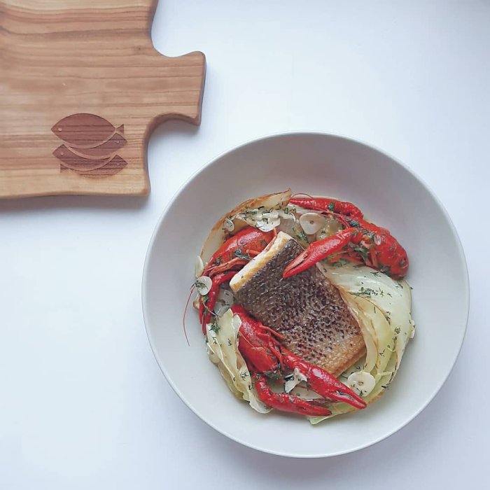 Baltic salmon fried with white cabbage, crayfish in butter sauce with garlic, dill and lemon zest